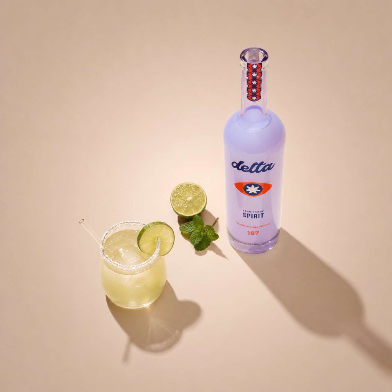 A skinny margarita with salt rim and lime wheel garnish next to the Spirit bottle on a beige background.